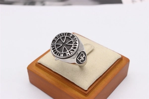 Macro shot of retro stainless steel Knights Templar cross ring with Latin engraving