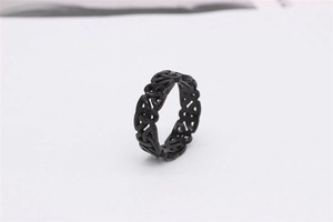 Detailed view of the black Celtic knot cutout design on this vintage titanium steel ring