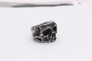 Macro detail of retro skull ring with vintage silver finish and lava texture surface