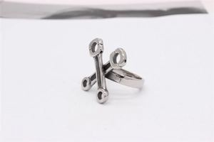 Detailed close-up of a titanium steel ring featuring a vintage piston rod design