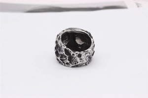 Close-up of vintage skull ring with textured meteor crater surface in antique silver finish