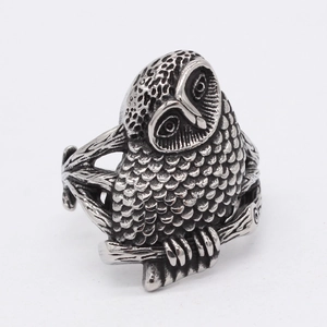 Retro vintage stainless steel owl ring for men with detailed feather engraving on white background