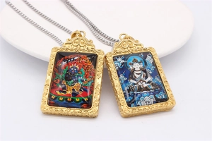 Detail of vintage stainless steel zodiac amulets with colorful Buddhist patterns