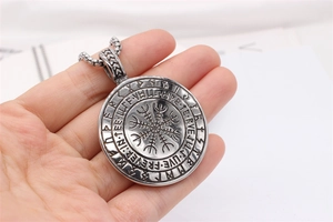 Macro shot of Viking Vegvisir compass pendant with runes and thick square pearl chain