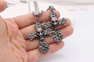 Macro detail of gothic cross skull pendants with red and blue rhinestone accents