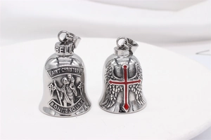 Detail of vintage steel bell pendants with Saint Christophe relief and red cross motif