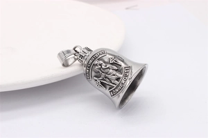 Macro detail of vintage Saint Christopher bell pendant with relief and Bonne Route text