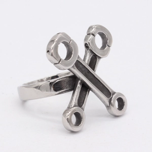 Retro stainless steel wrench ring with industrial cross design for men on white background