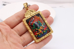 Detailed close-up of retro golden stainless steel Buddha pendant with Thangka artwork