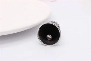Detailed close-up of a silver bell pendant with a polished finish and internal striker