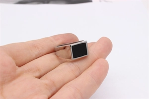 Detailed view of silver stainless steel signet ring for men with black rectangular inlay