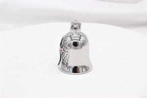 Detail of vintage steel bell pendant with red cross and feather wing engravings