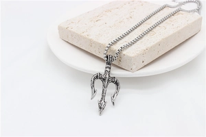 Detailed view of vintage trident pendant necklace with engraved texture on stone display