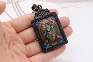 Macro shot of rectangular zodiac protector pendant with black vintage engraved frame