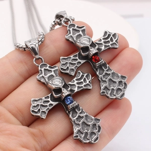 Gothic retro skull cross pendant necklaces with red and blue gemstones in hand