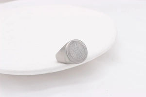 Detailed macro view of retro compass engraved stainless steel ring with matte finish