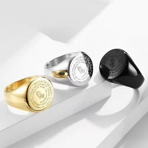 Close-up of Serenity Prayer and praying hands engraved on vintage men's steel signet rings