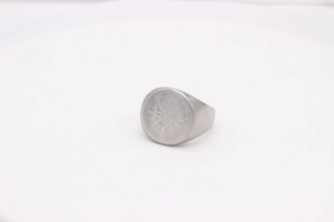 Macro shot of vintage compass star engraving on stainless steel signet ring for men