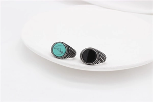 Macro view of vintage titanium steel rings with turquoise and black onyx gemstones