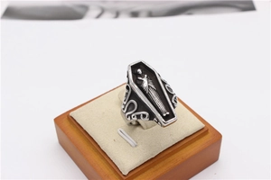 Detail view of gothic mummy coffin ring with vintage silver embossed carving and scrollwork