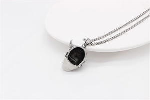 Detailed close-up of retro silver demon mask pendant with durable stainless steel box chain