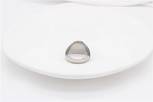 Macro view of textured vintage titanium steel ring with intricate side engraving details