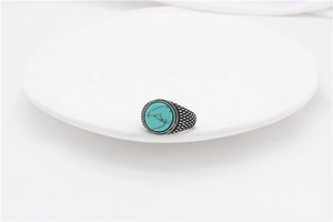 Macro shot of vintage turquoise gemstone set in a textured stainless steel ring