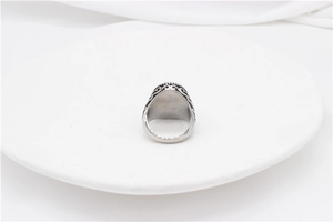 Macro detail of retro stainless steel ring with vintage engraved patterns and black oxidation
