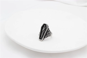 Macro view of gothic coffin ring featuring detailed skull skeleton relief engraving