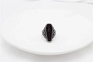 Detail of gothic mummy coffin ring featuring a purple phantom totem and punk scrollwork