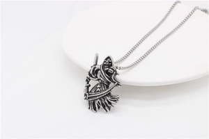 Detailed view of silver grim reaper pendant with scythe in gothic punk style
