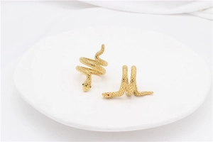 Detailed close-up of golden snake spiral rings featuring intricate scale textures and gemstones