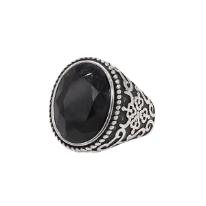 Vintage stainless steel ring with oval black gemstone and intricate floral engravings