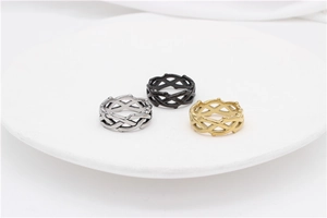 Detailed view of three thorn crown steel rings in silver, black and gold finishes