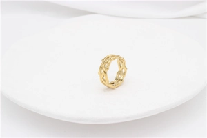 Detailed close-up of a gold thorn crown ring with a hollow woven vine design on white background