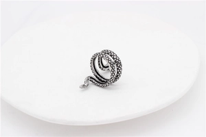Macro shot of vintage silver snake ring showing intricate scale textures and antique finish