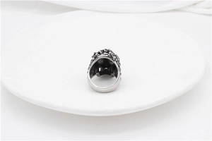 Top view of retro gothic skull ring featuring oxidized texture and vintage metal engraving