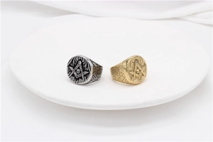 Detail of vintage Masonic signet rings in gold and silver steel with skull and compass engraving