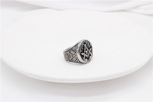 Macro view of vintage Freemason skull ring with intricate geometric engravings on steel