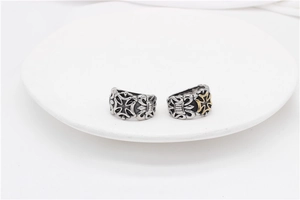 Macro shot of two vintage Gothic rings with Maltese cross engravings on a white plate