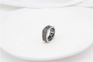 Detailed macro shot of vintage punk square black gemstone ring with woven texture band