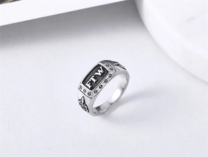 Macro view of vintage FTW men's stainless steel ring with bullet relief and screw details
