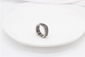 Detailed macro view of the vintage woven texture and S925 hallmark on silver ring