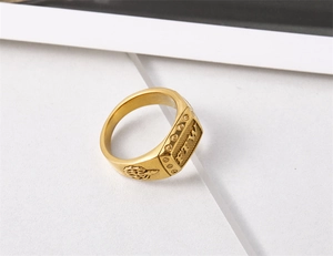 Macro shot of gold signet ring with FTW engraving and vintage biker flame textures