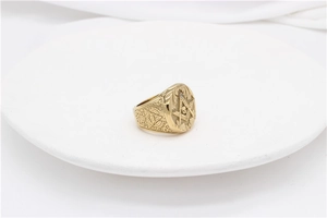 Close-up of gold masonic skull ring with Eye of Providence and vintage patterns