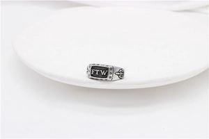 Macro shot of vintage stainless steel ring with FTW engraving and textured details