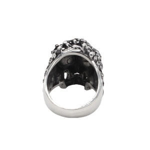 Vintage punk skull ring in silver titanium steel with rustic embossed metal texture