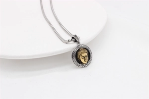 Detail of Buddha pendant with gold relief on silver textured disc and silver box chain