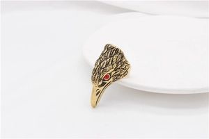 Macro view of vintage eagle head ring with detailed feathers and red gemstone eye