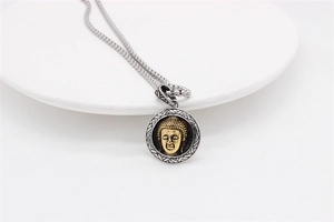 Close-up of dual-tone Buddha pendant with intricate silver weave pattern and gold head